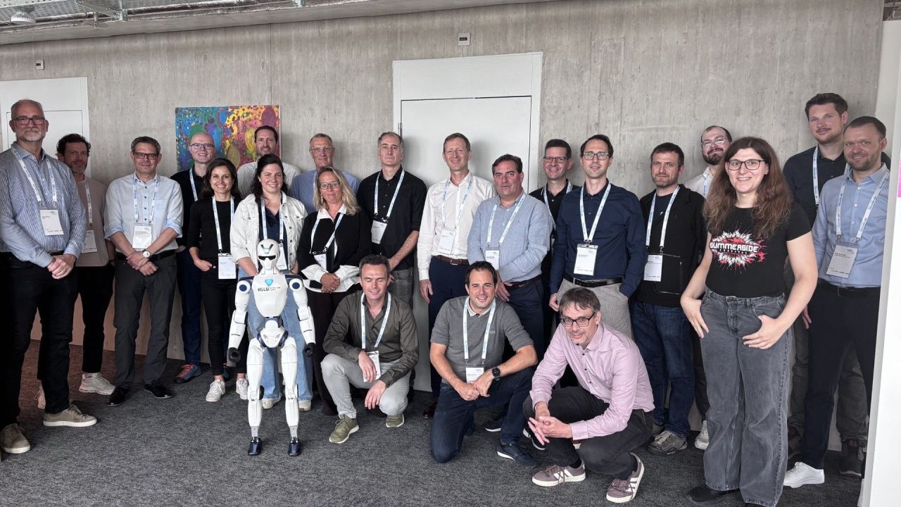 Group photo at the Next Industries practice circle at HSLU, with the humanoid robot Unitree R1